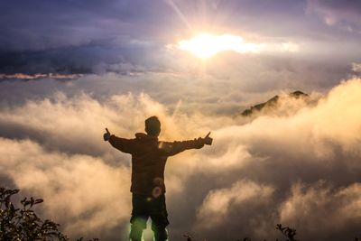 man facing clouds during golden time.